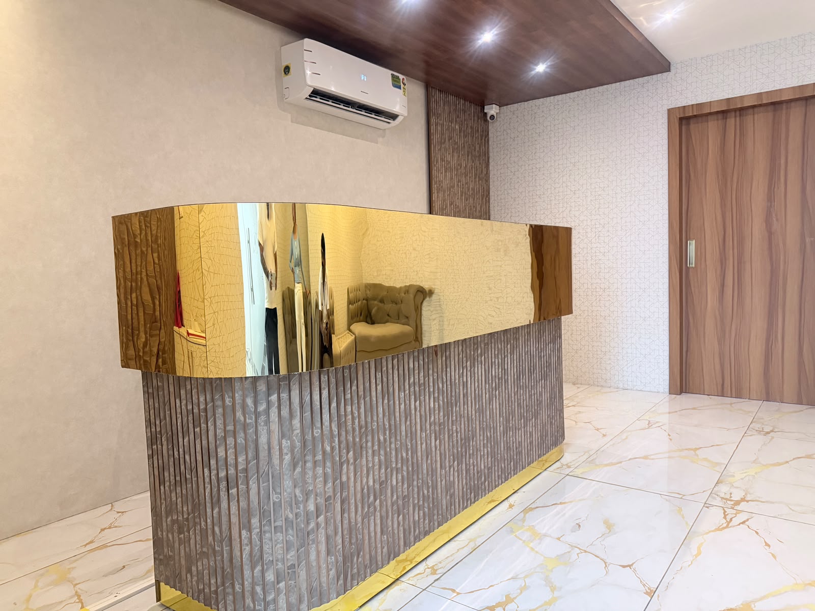 Gold-finish reception desk at the entrance of KEVA Luxury Spaa, Hennur, Bangalore